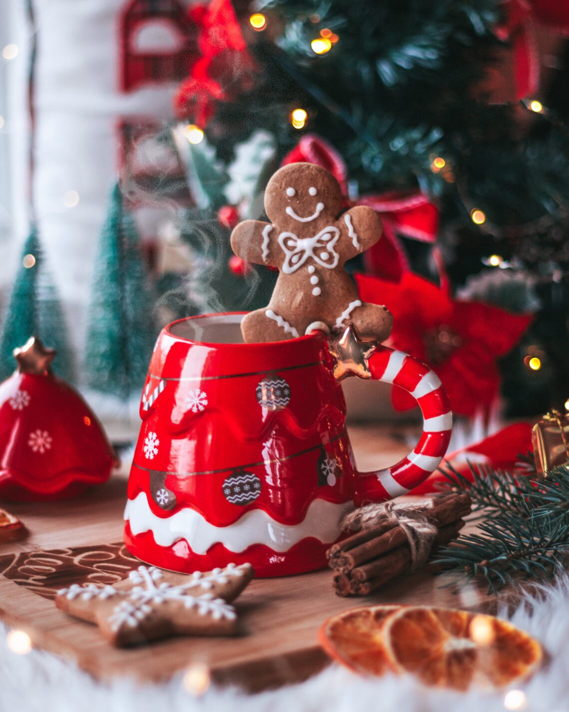 Festive Cookie Exchange Party Decorations featuring an adorable gingerbread man balancing on a red and white Christmas mug.