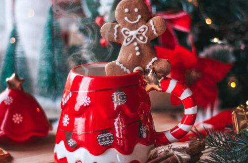 Festive Cookie Exchange Party Decorations featuring an adorable gingerbread man balancing on a red and white Christmas mug.