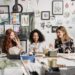 Women sitting around a table painting and laughing